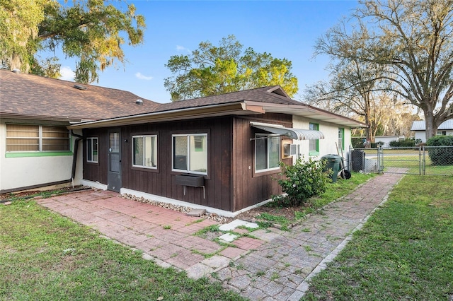 view of side of property with cooling unit and a yard