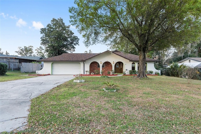 ranch-style home featuring a garage and a front lawn