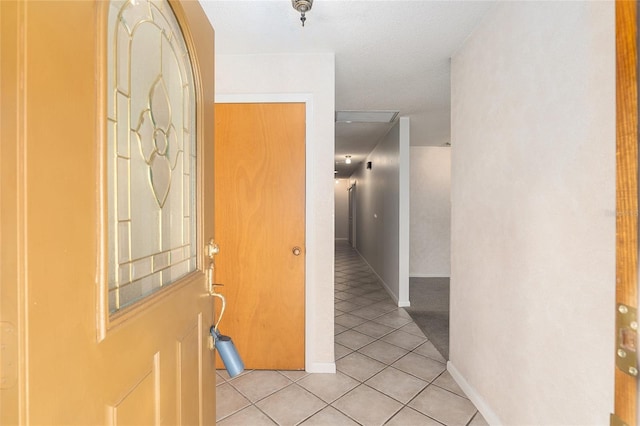 corridor with light tile patterned floors