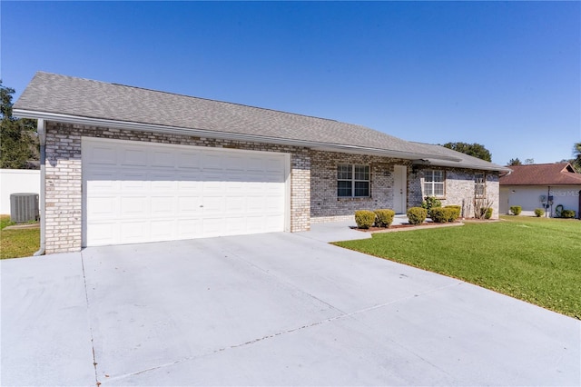 ranch-style home with cooling unit, a garage, brick siding, concrete driveway, and a front lawn