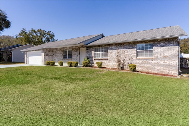 ranch-style home with an attached garage, brick siding, and a front yard