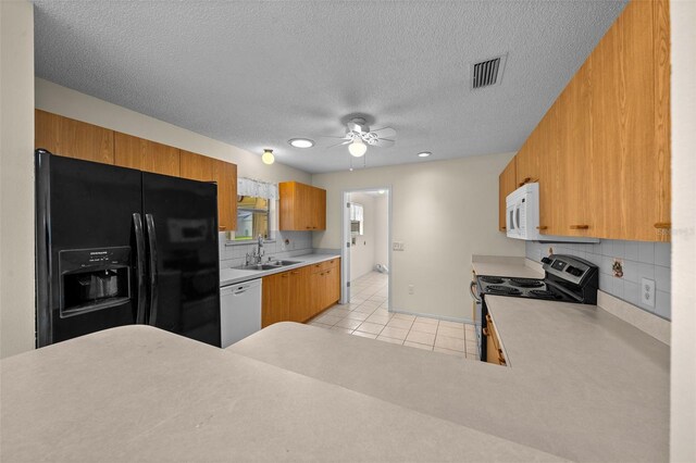 912 Chula Ct, Lady Lake, FL 32159 - kitchen featuring light tile patterned flooring, sink, backsplash, ceiling fan, and white appliances
