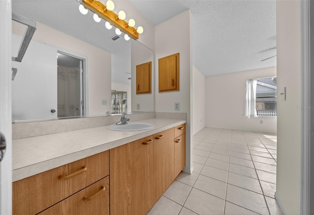 912 Chula Ct, Lady Lake, FL 32159 - bathroom with vanity, tile patterned floors, and a textured ceiling