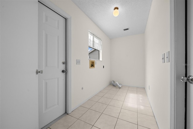 912 Chula Ct, Lady Lake, FL 32159 - laundry room with light tile patterned floors, hookup for a washing machine, a textured ceiling, and electric dryer hookup