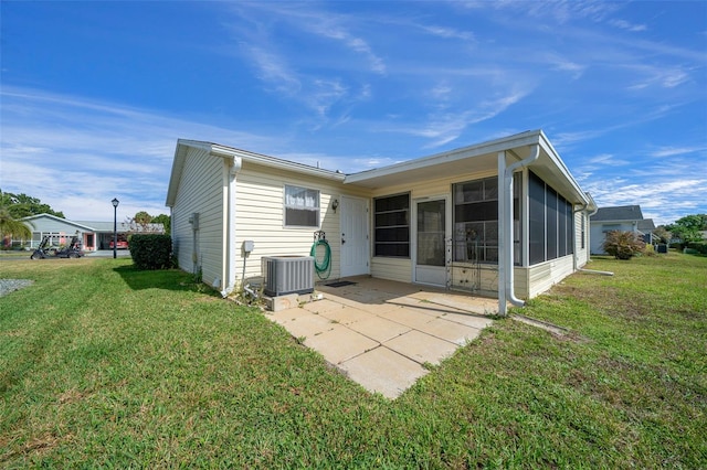 912 Chula Ct, Lady Lake, FL 32159 - back of property with a sunroom, a yard, central AC unit, and a patio area