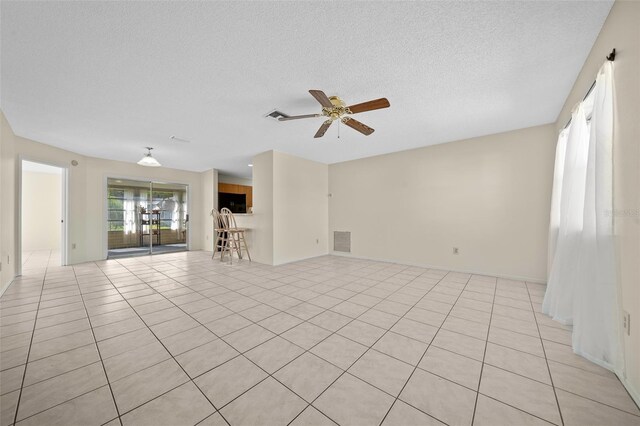 912 Chula Ct, Lady Lake, FL 32159 - tiled spare room with ceiling fan and a textured ceiling