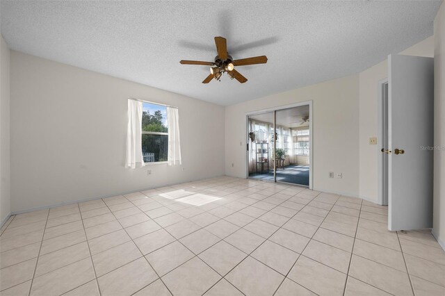 912 Chula Ct, Lady Lake, FL 32159 - spare room featuring ceiling fan, light tile patterned floors, and a textured ceiling