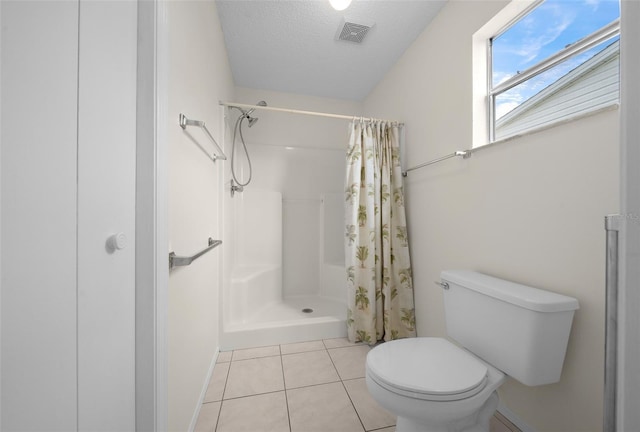 912 Chula Ct, Lady Lake, FL 32159 - bathroom featuring tile patterned floors, toilet, a textured ceiling, and walk in shower