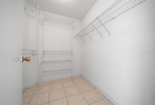 912 Chula Ct, Lady Lake, FL 32159 - walk in closet with light tile patterned flooring