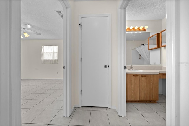 912 Chula Ct, Lady Lake, FL 32159 - bathroom featuring vanity, tile patterned flooring, and a textured ceiling