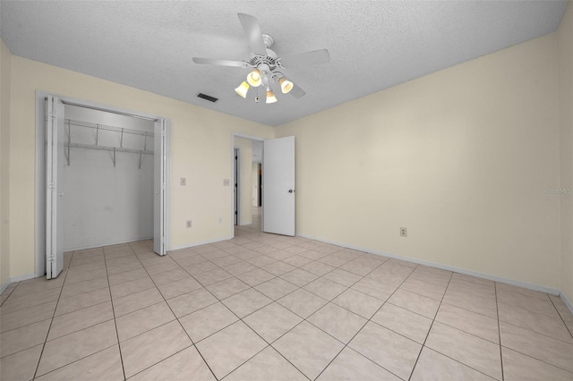 912 Chula Ct, Lady Lake, FL 32159 - unfurnished bedroom with a textured ceiling, ceiling fan, and a closet
