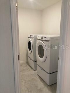 clothes washing area with laundry area and independent washer and dryer