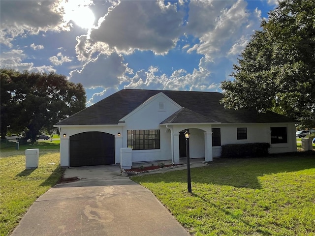 single story home featuring a garage and a front lawn