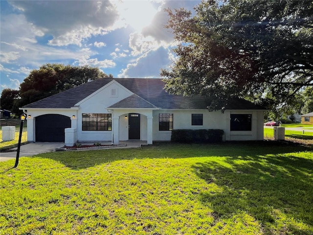 ranch-style house with a garage and a front lawn