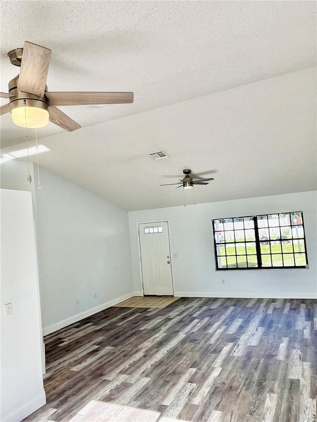 spare room with ceiling fan, wood-type flooring, a textured ceiling, and lofted ceiling