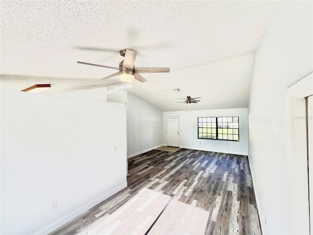 interior space with vaulted ceiling, wood-type flooring, ceiling fan, and a textured ceiling