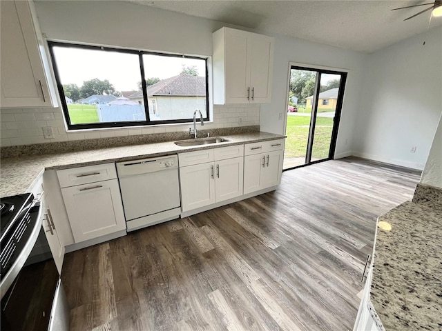 kitchen featuring sink, white cabinetry, range with electric stovetop, dishwasher, and light stone countertops