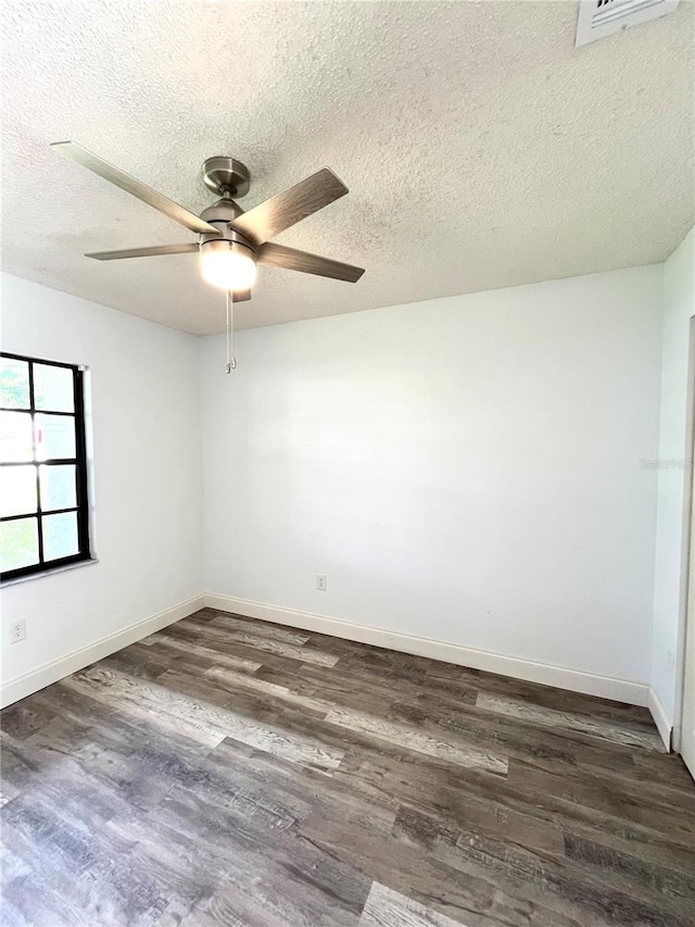 unfurnished room with dark wood-type flooring, ceiling fan, and a textured ceiling