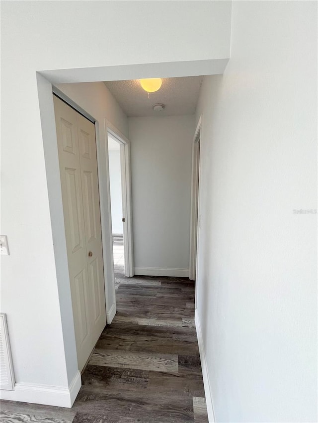 hall with dark hardwood / wood-style flooring