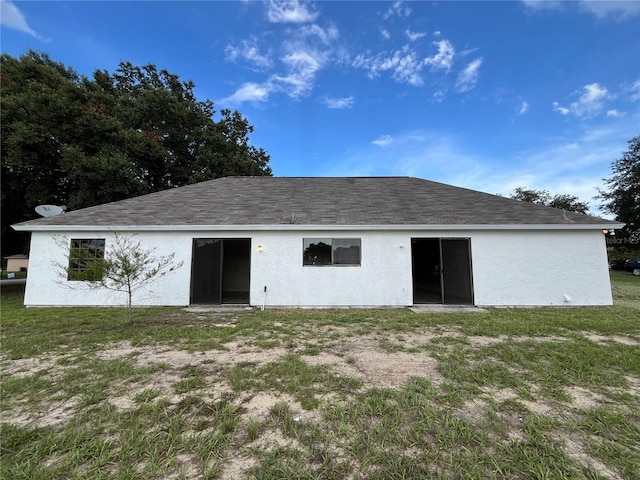 rear view of house with a yard