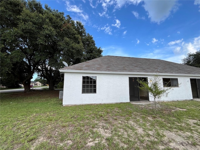 rear view of property featuring a yard