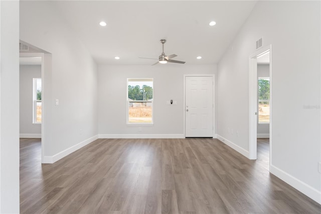 unfurnished room with ceiling fan, plenty of natural light, and light wood-type flooring