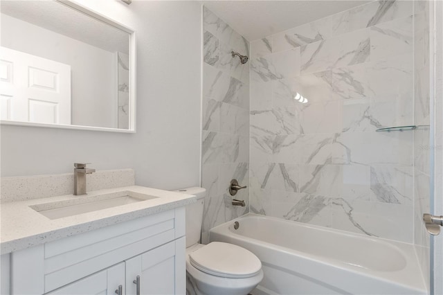 full bathroom featuring tiled shower / bath combo, vanity, and toilet