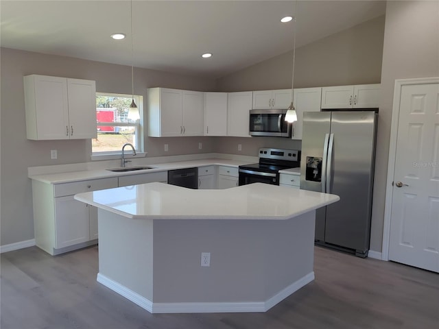 kitchen with a sink, a kitchen island, stainless steel appliances, and light countertops