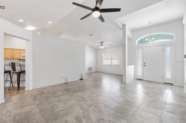 entrance foyer with high vaulted ceiling, recessed lighting, ceiling fan with notable chandelier, visible vents, and baseboards