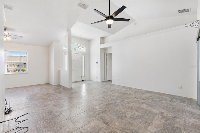 interior space featuring visible vents, vaulted ceiling, and ceiling fan with notable chandelier