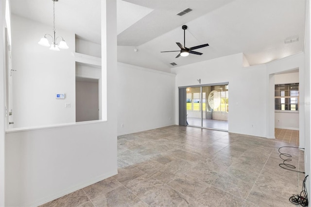 empty room featuring a wealth of natural light, visible vents, vaulted ceiling, and ceiling fan with notable chandelier