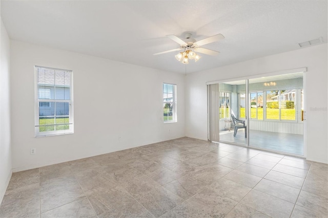 spare room with a ceiling fan and visible vents