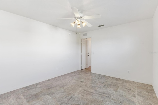 spare room with ceiling fan and visible vents