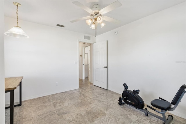 exercise area featuring a ceiling fan, visible vents, and baseboards