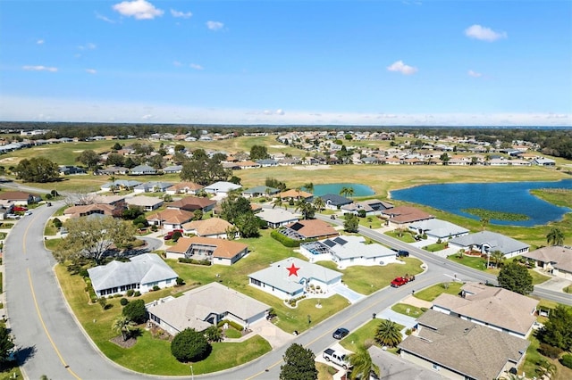 drone / aerial view featuring a water view and a residential view