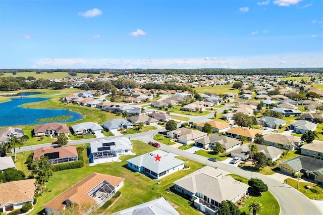 birds eye view of property with a water view and a residential view