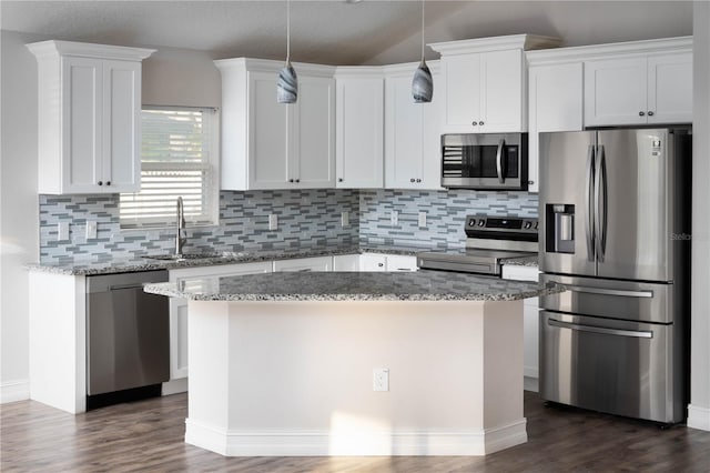 kitchen with white cabinetry, appliances with stainless steel finishes, and a kitchen island