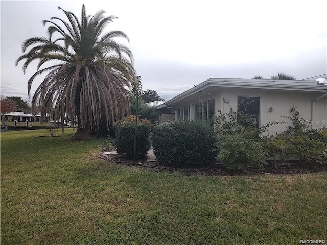 view of property exterior with a yard