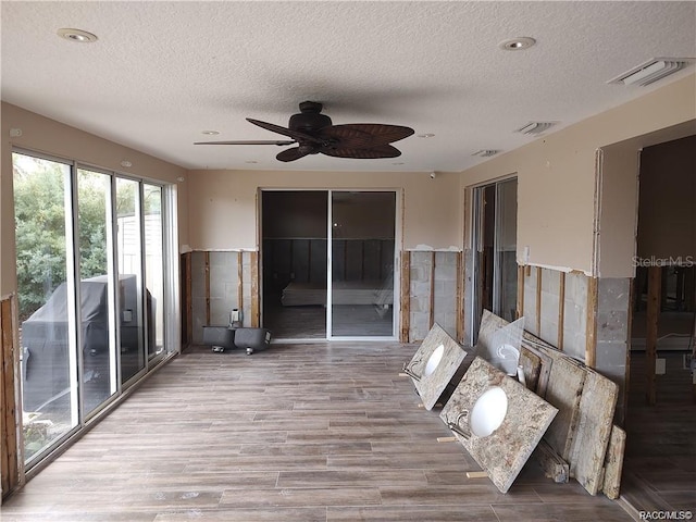 interior space with visible vents and a ceiling fan