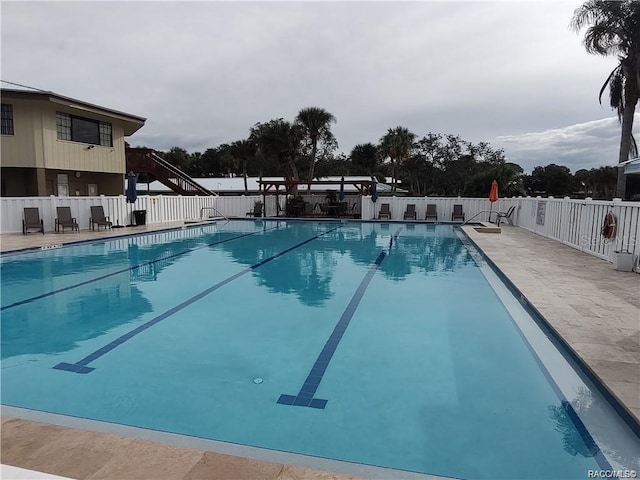 pool featuring a patio area and fence