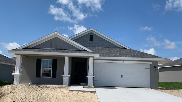 336 W Twisted Oaks Dr, Beverly Hills, FL 34465 - view of front of home with a shingled roof, an attached garage, driveway, a porch, and board and batten siding