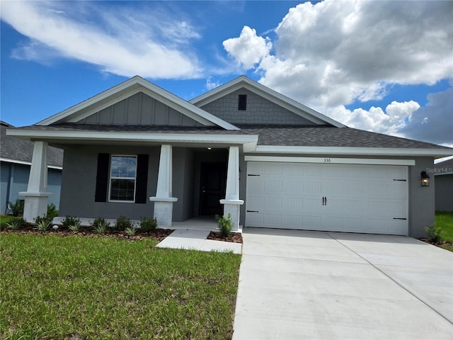 336 W Twisted Oaks Dr, Beverly Hills, FL 34465 - craftsman inspired home with an attached garage, driveway, a shingled roof, a front lawn, and board and batten siding