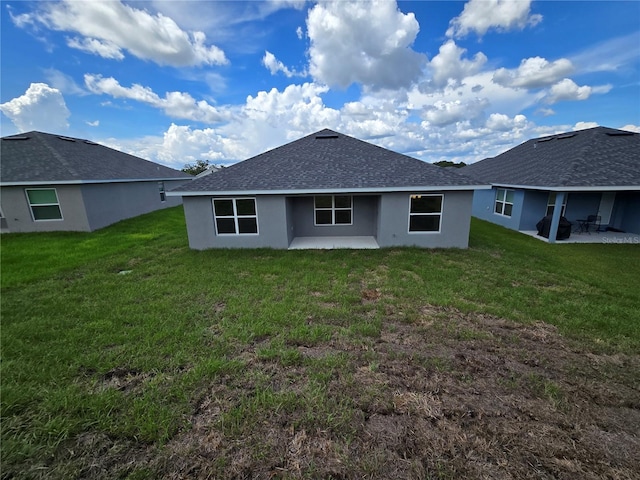 336 W Twisted Oaks Dr, Beverly Hills, FL 34465 - back of property featuring a patio, a yard, stucco siding, and roof with shingles