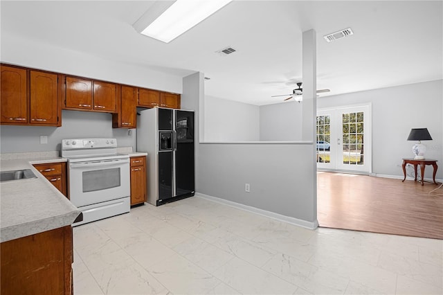 23761 SW Plaza Ct, Dunnellon, FL 34431 - kitchen with electric stove, sink, ceiling fan, and black fridge