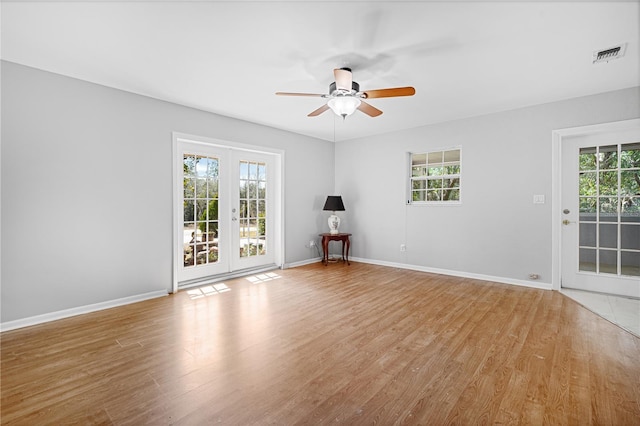 23761 SW Plaza Ct, Dunnellon, FL 34431 - empty room with ceiling fan, light hardwood / wood-style flooring, and french doors