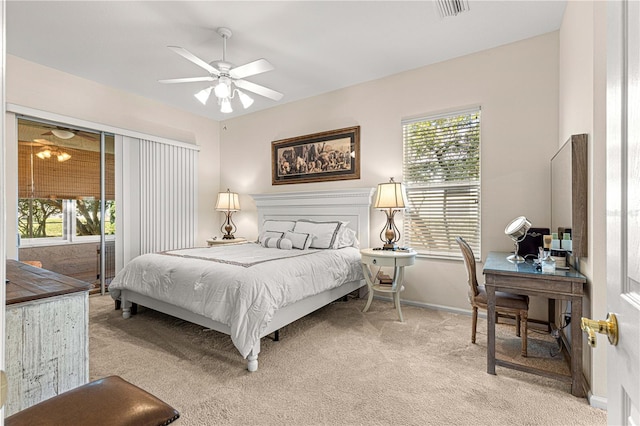 bedroom featuring light carpet, multiple windows, and ceiling fan