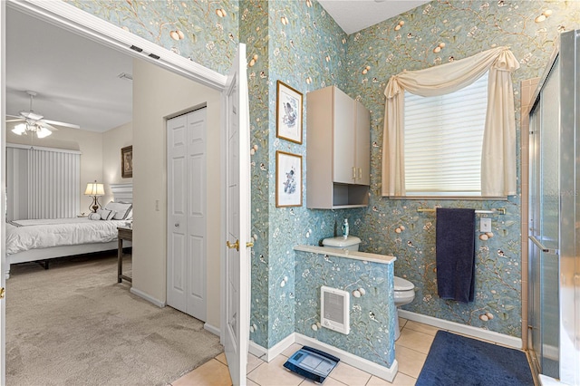 bathroom with ceiling fan, toilet, and tile patterned flooring