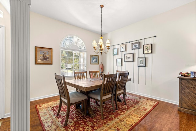 dining area featuring a notable chandelier and dark hardwood / wood-style flooring