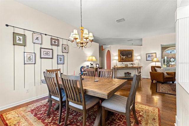 dining space featuring an inviting chandelier and dark hardwood / wood-style floors