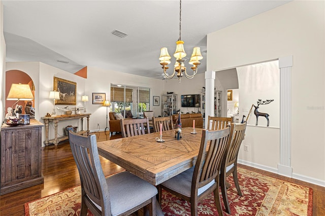 dining room featuring dark hardwood / wood-style flooring and a chandelier